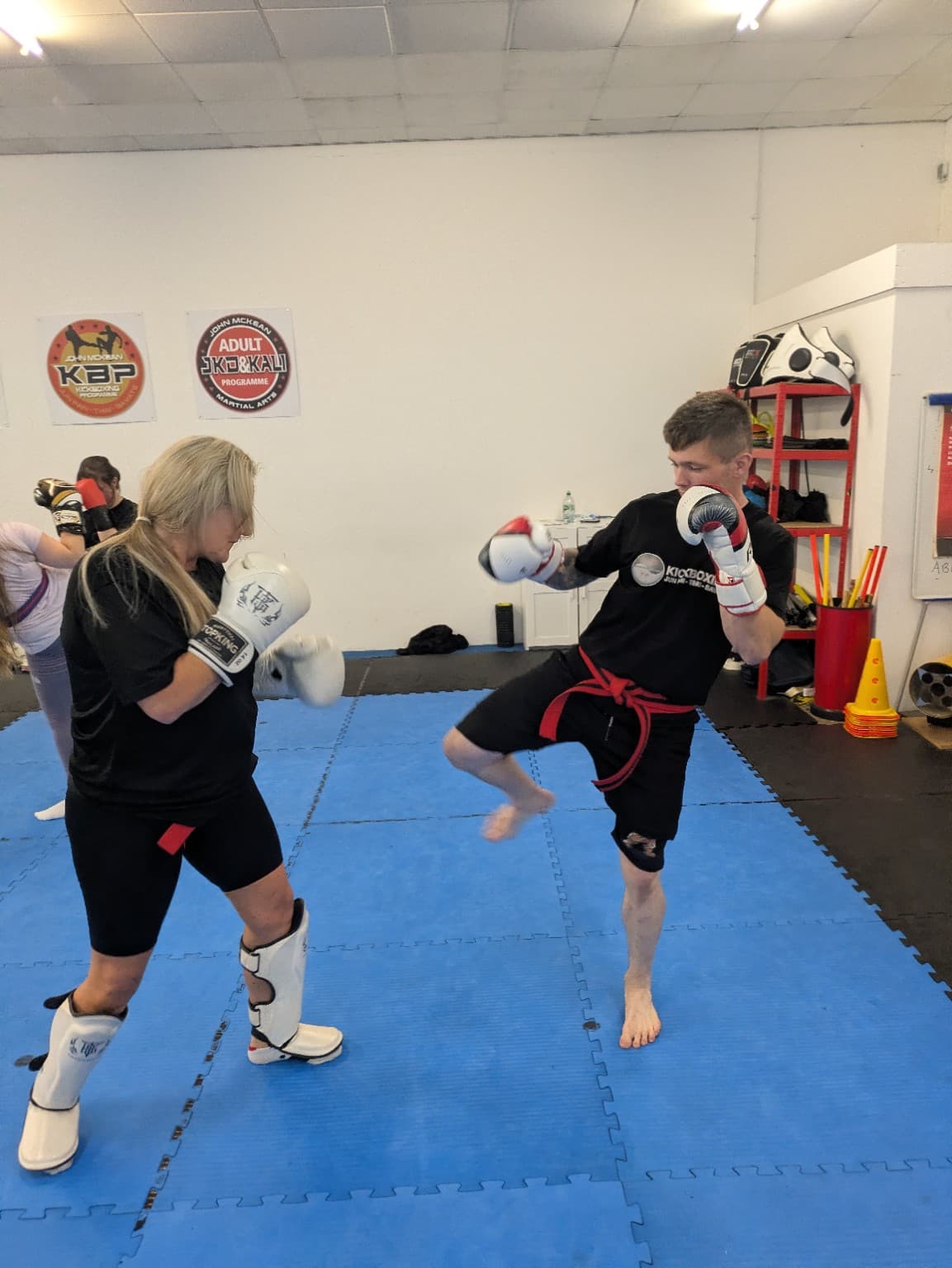 Martial arts students practising a kickboxing technique